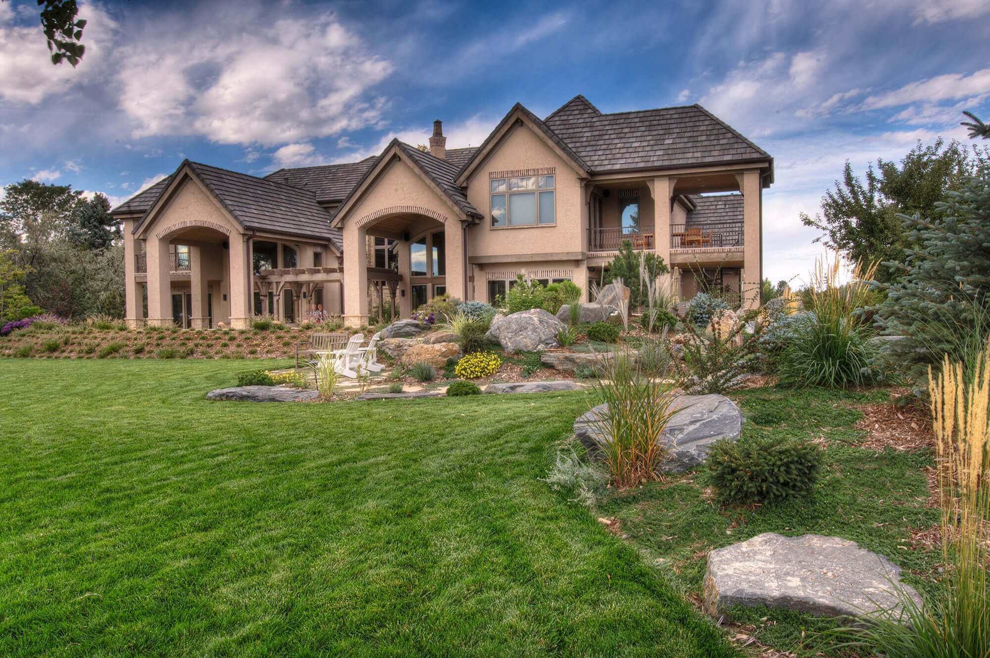 Backyard view of the house, lawn, and chairs