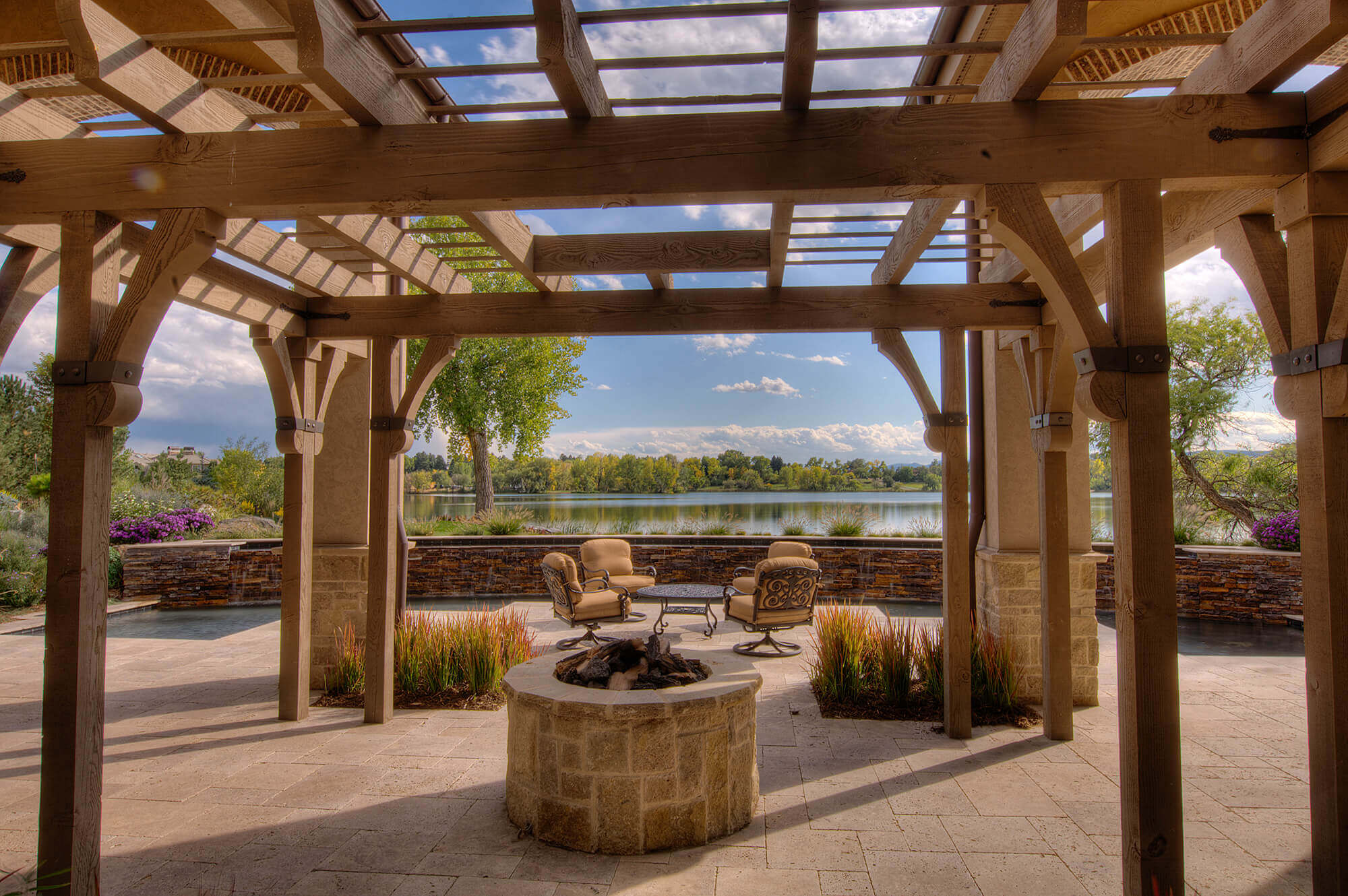 Backyard area with some chairs, tables, swimming pool along with fire pit