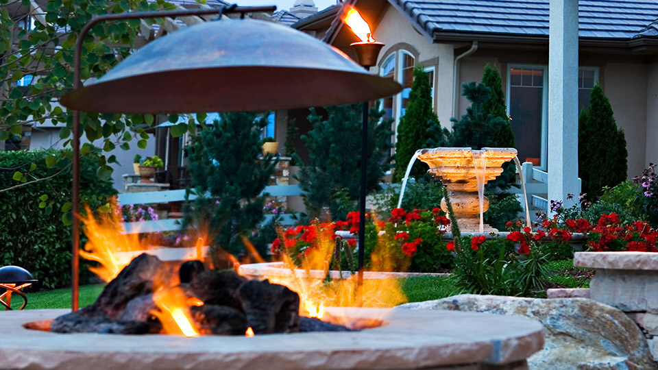 Fire pit in the backyard along with water fountain