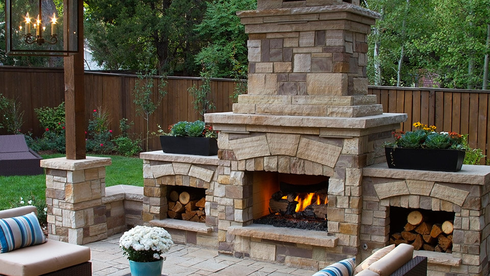 Outdoor chimney by the sitting area along with chairs in the backyard