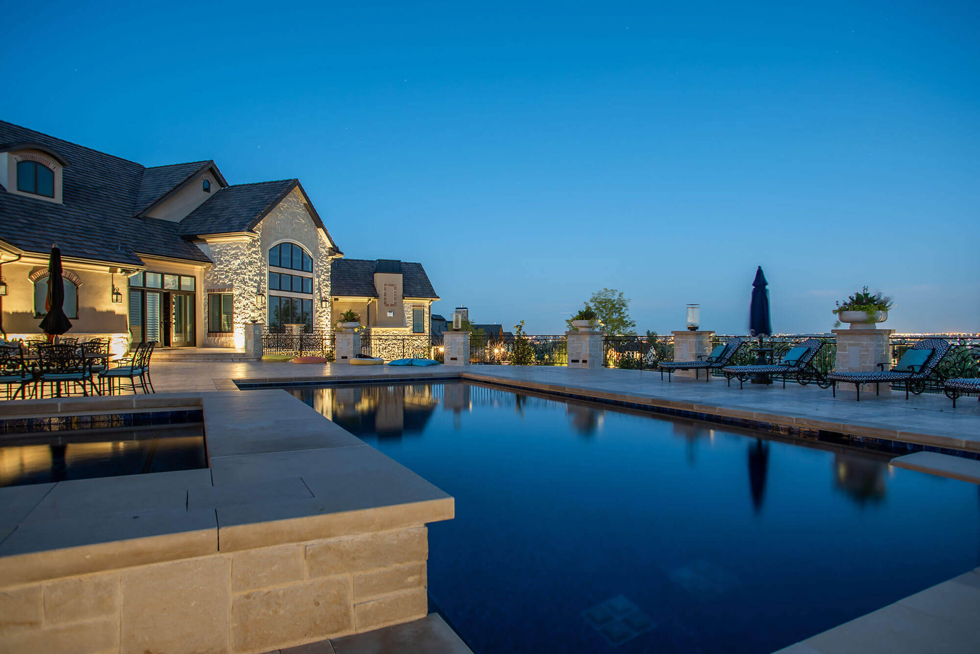 View of the backyard with swimming pool and lawn chairs