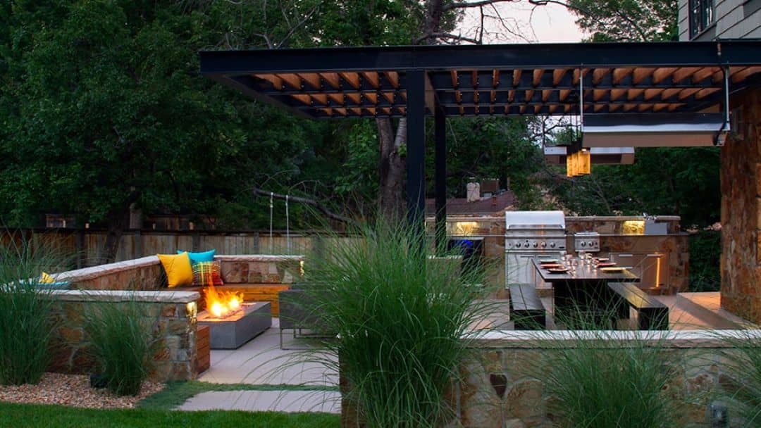 Outdoor Kitchen and Dining Space Surrounded by Greenery