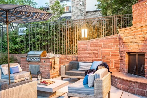Brick Outdoor Kitchen Featuring Outdoor Fireplace