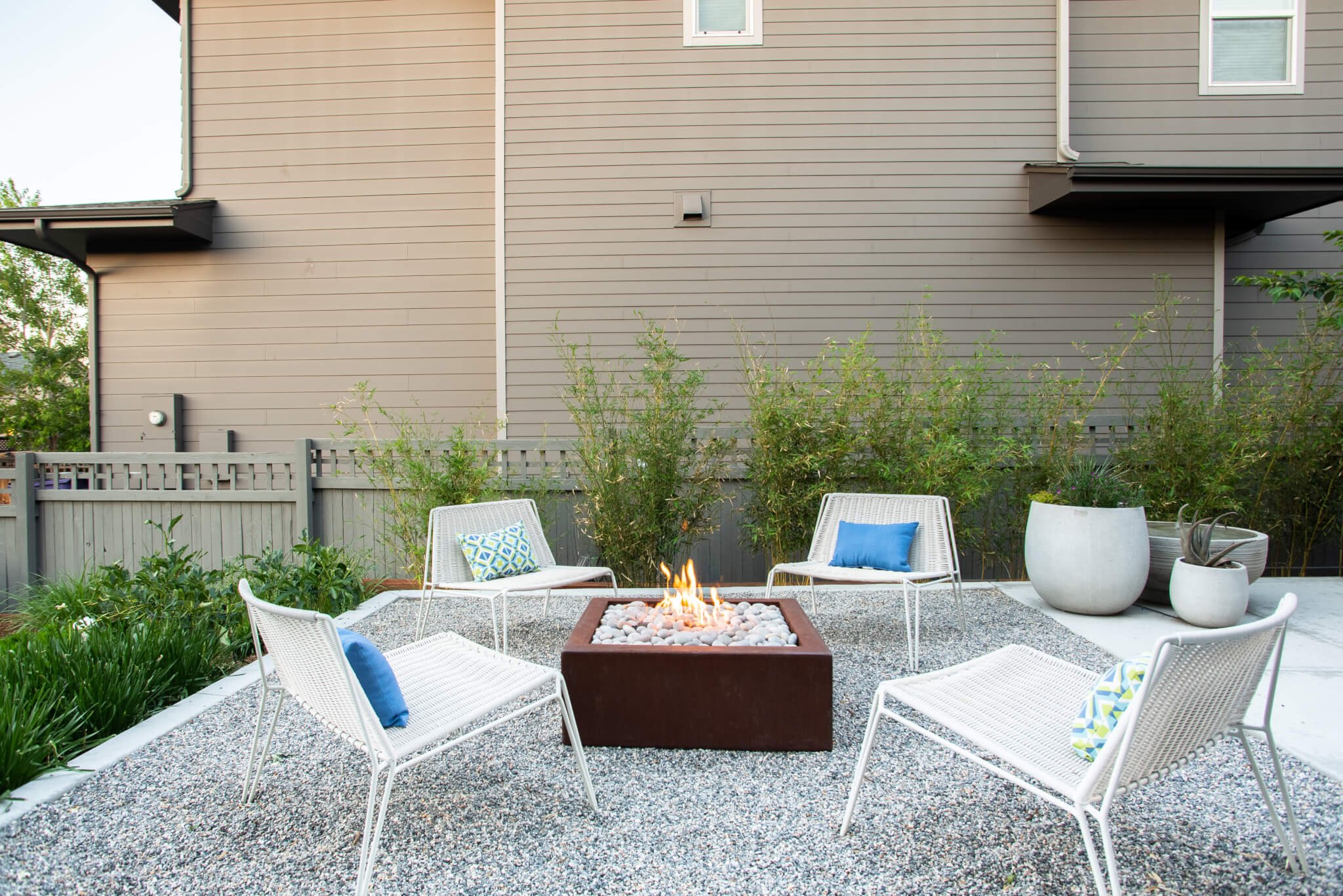 Fire pit surrounded by chairs in the backyard