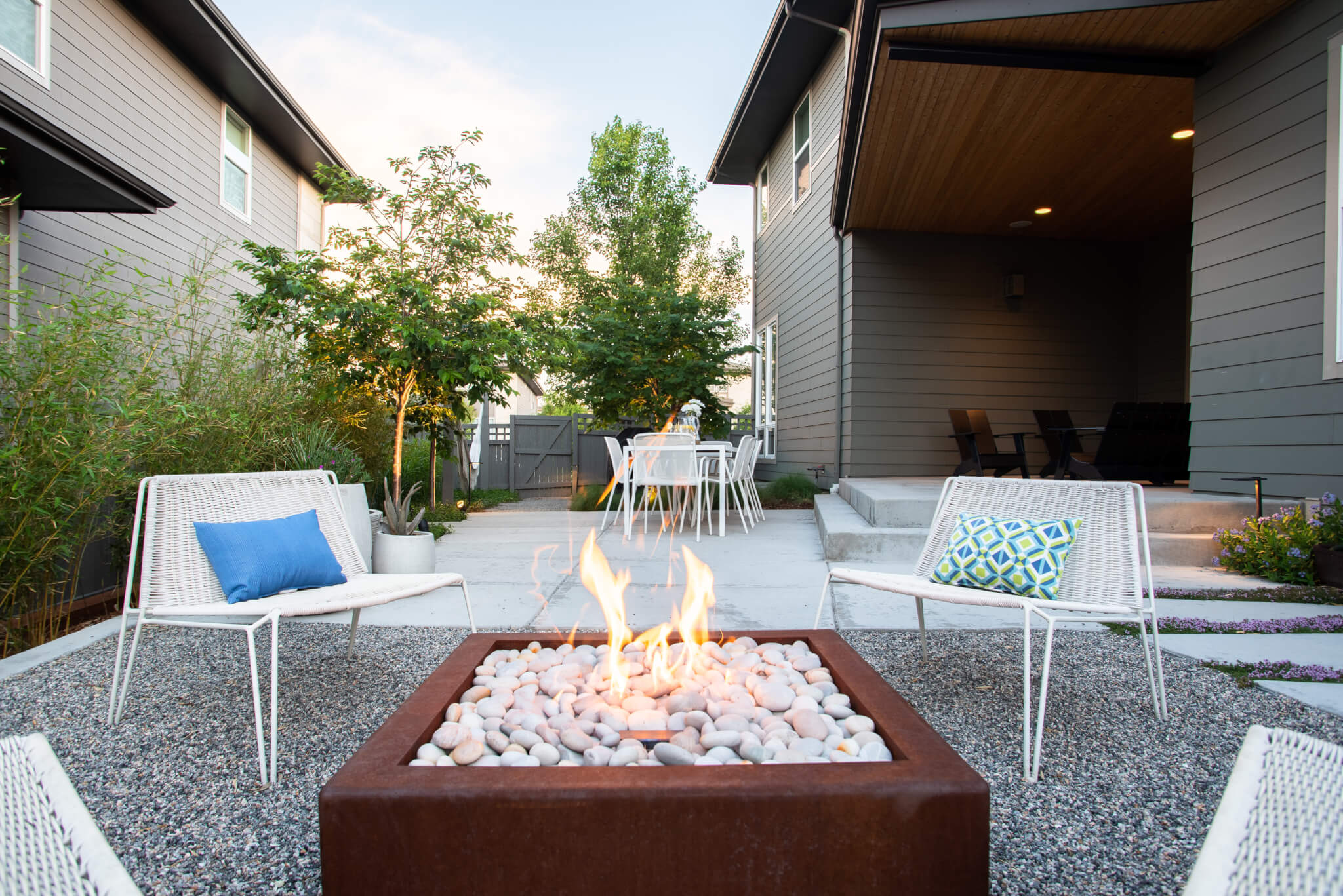 Fire pit surrounded by chairs in the backyard