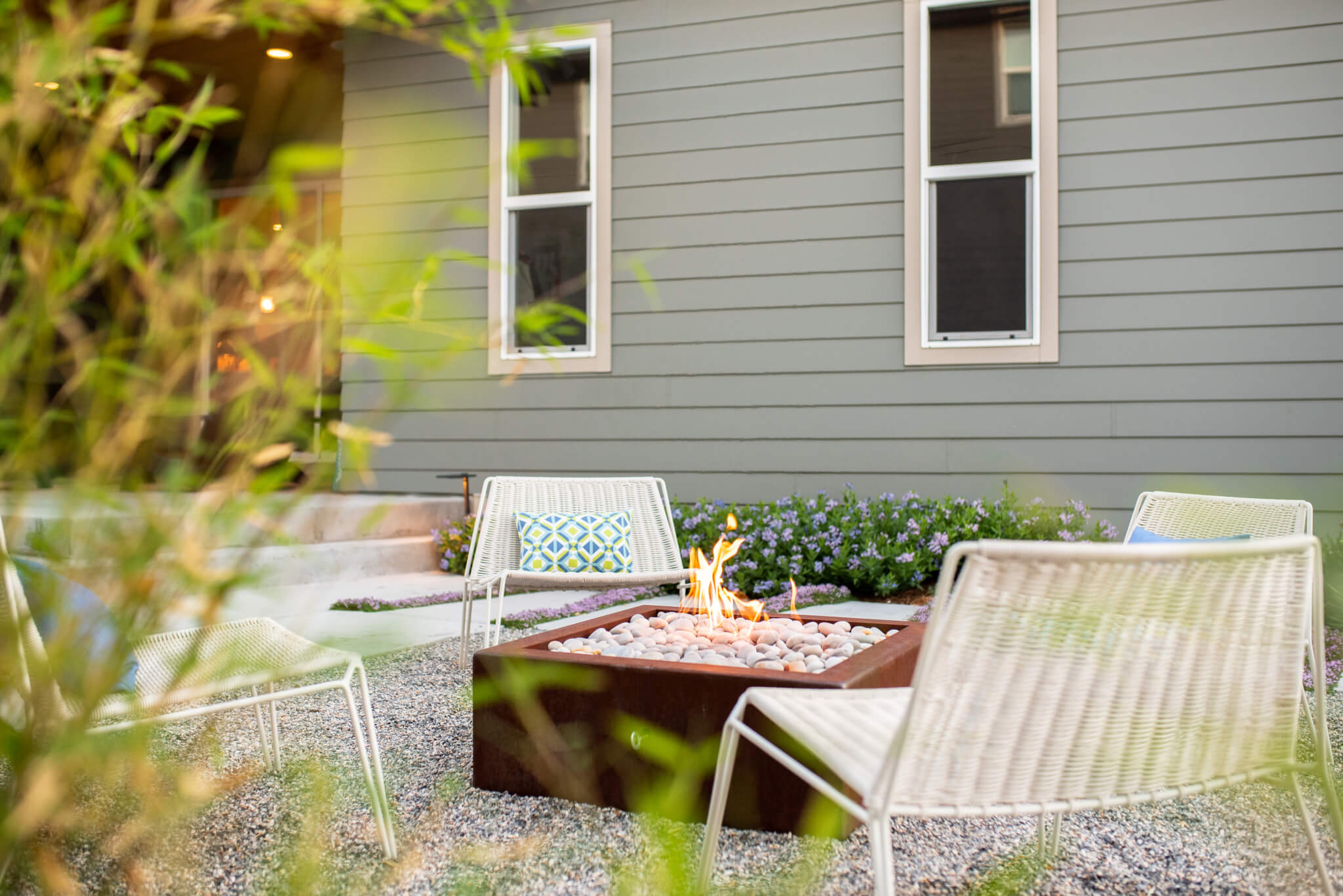 Fire pit surrounded by chairs in the backyard