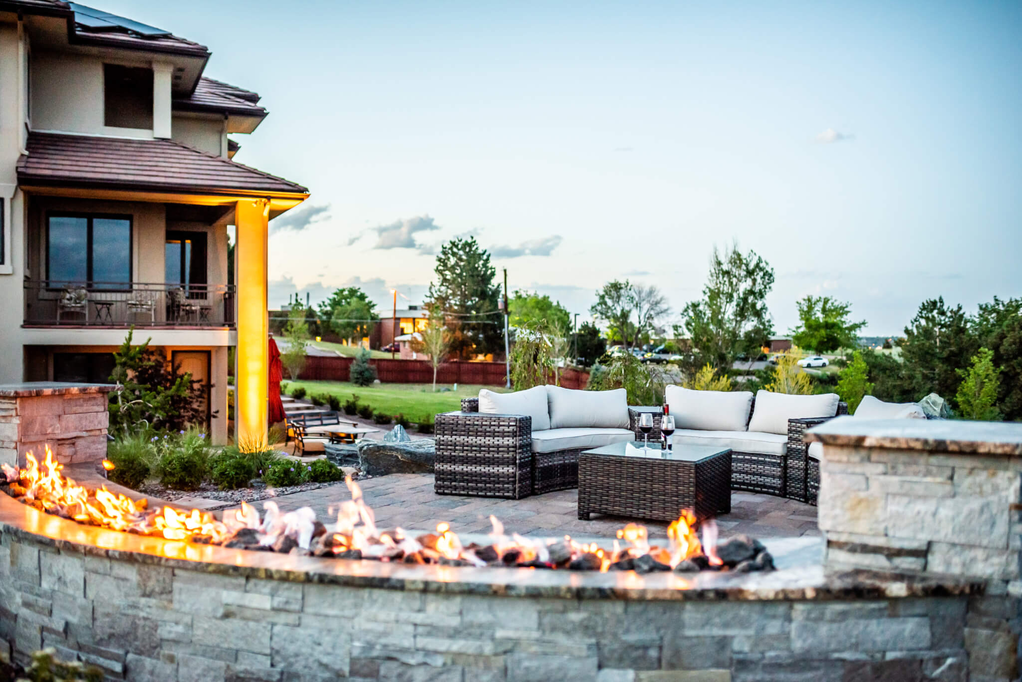 Side view of the house from the backyard with a fire pit, and sitting area