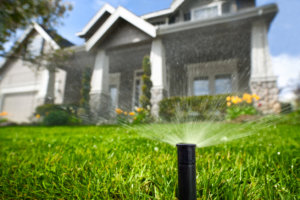 Sprinkler System Watering Grass in Front of Home