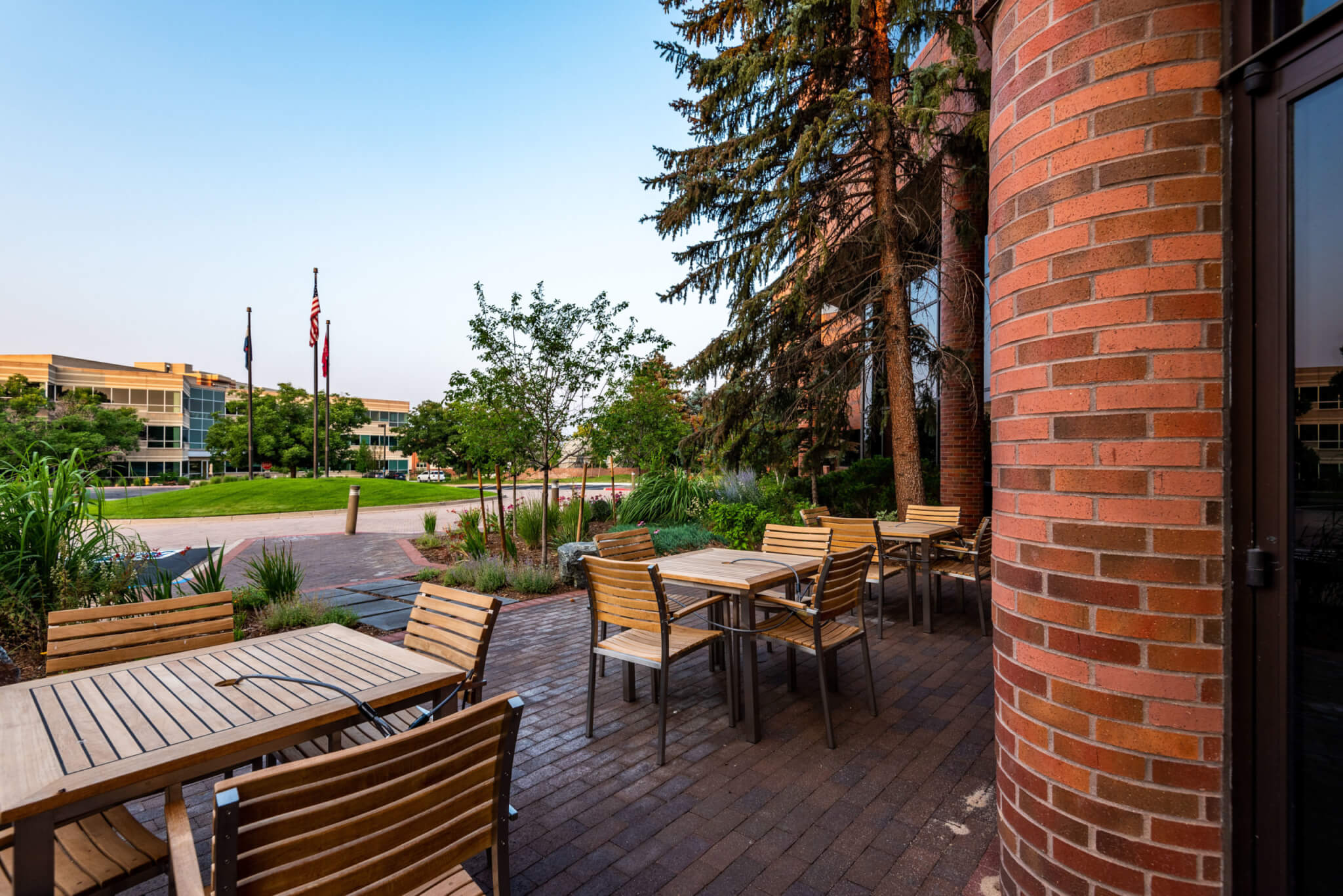 Outside sitting area with chairs and tables and distance view of other buildings