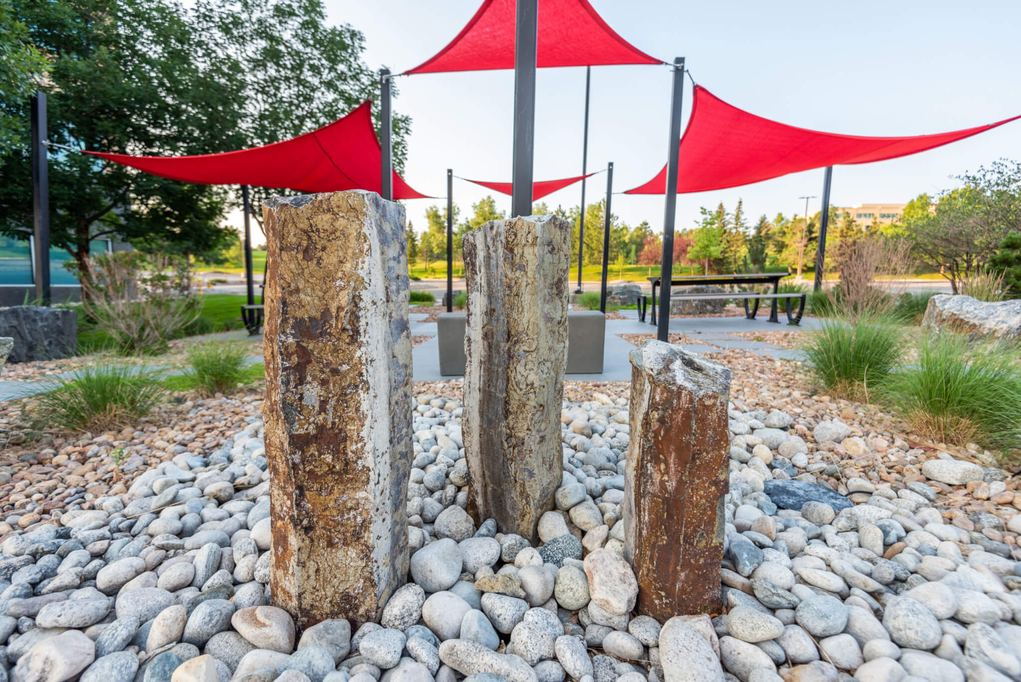 Three rock posts in the sitting area with grass plants