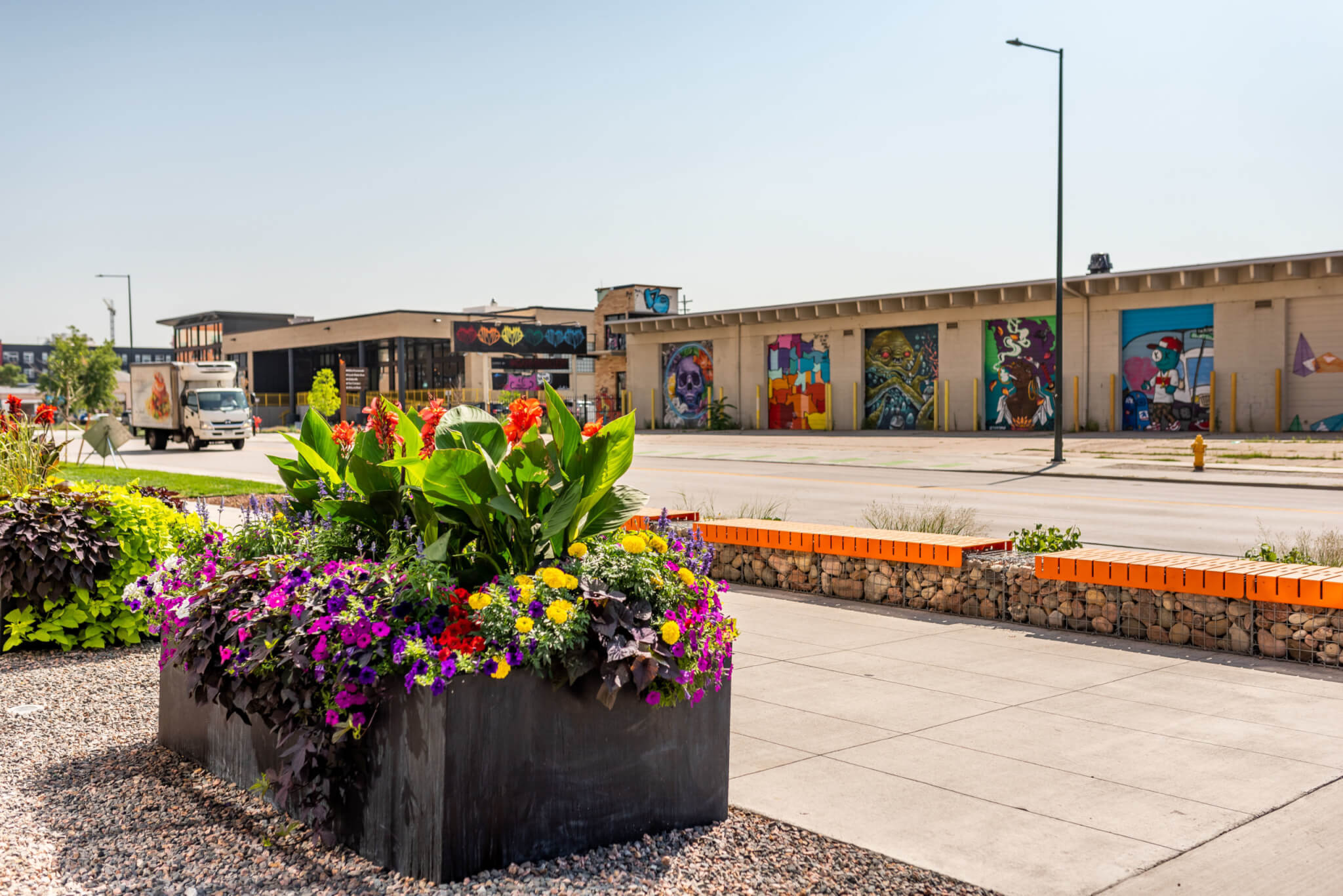 Big flower pot with different seasonal color flowers outside of a mall