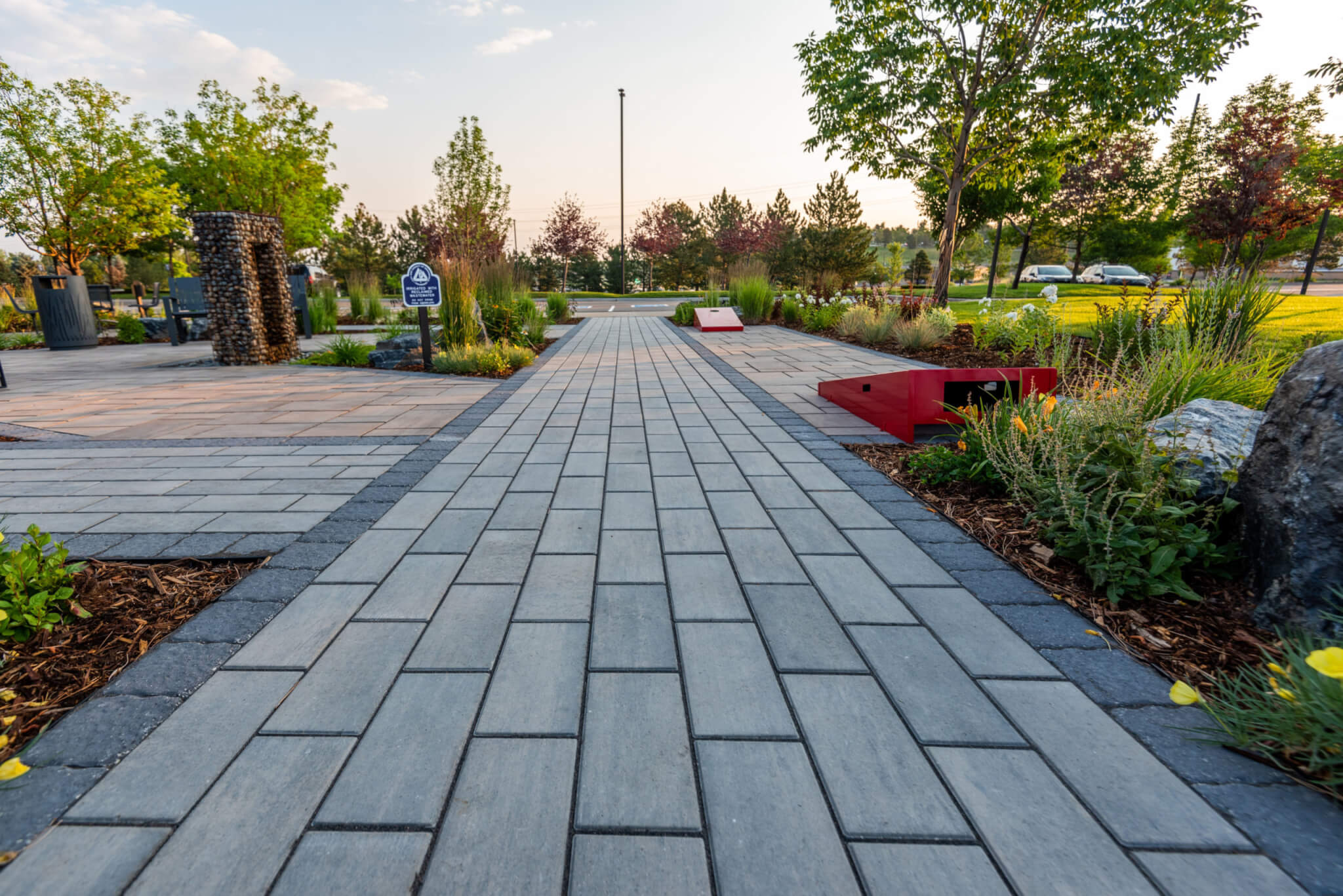 Path way leading to parking lot along with plants and trees