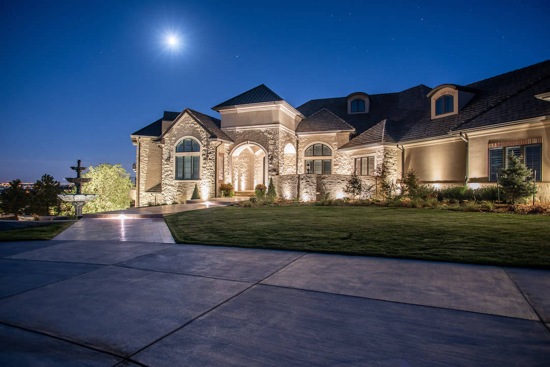 Mansion at Night Lit Up with Landscape Lighting