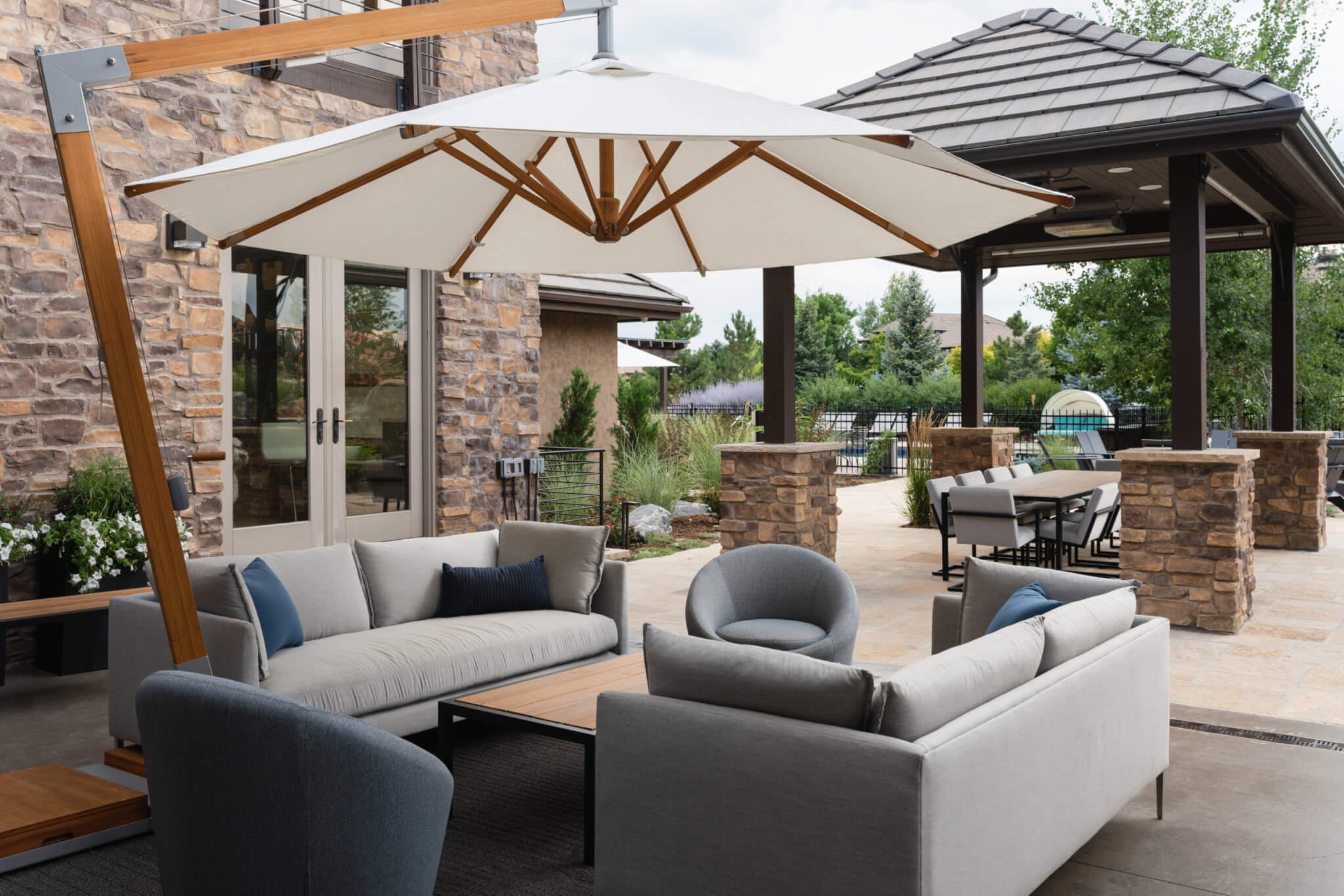 Sofa set with chairs, table, and gazebo in the backyard