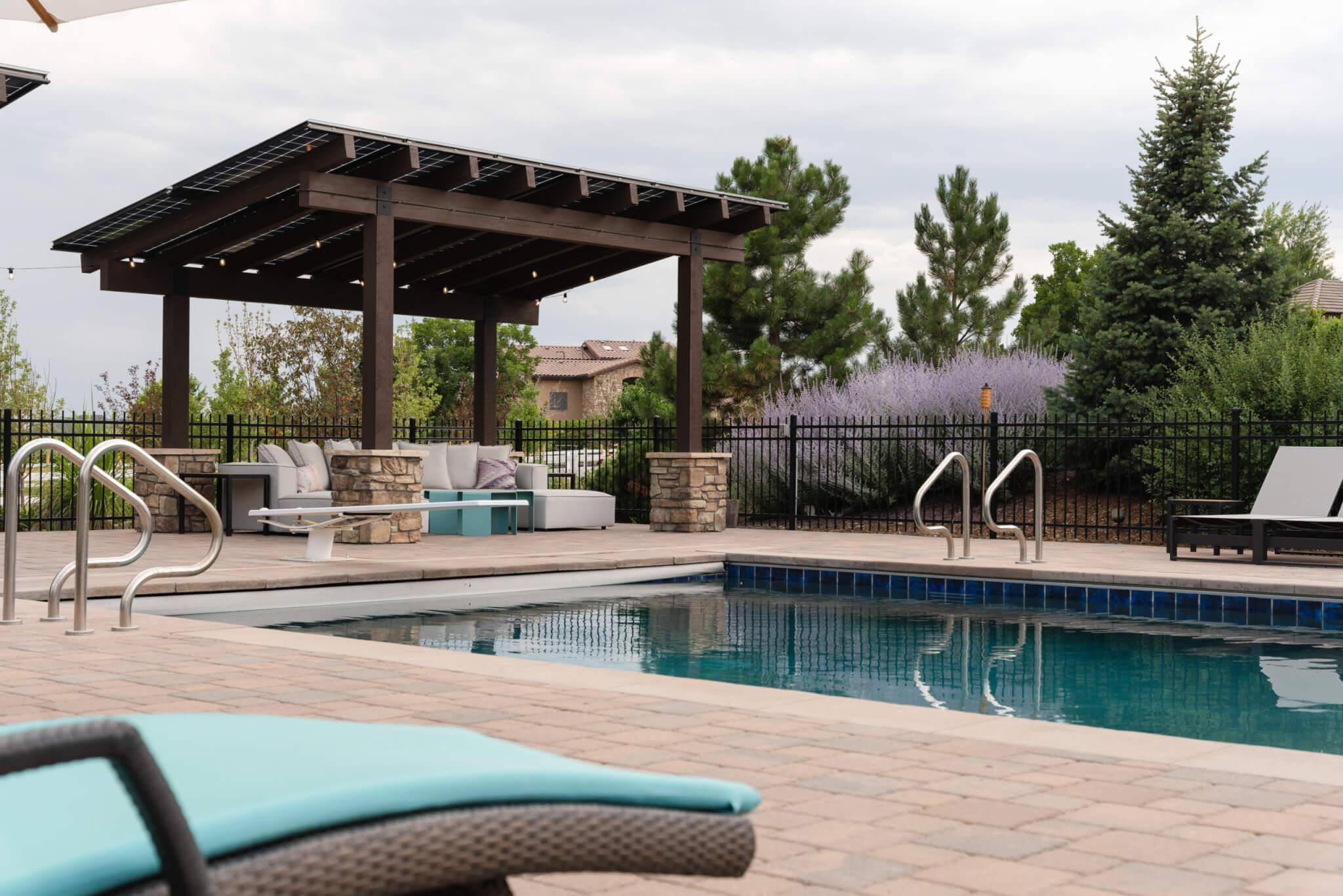 Swimming pool area with chairs, tables and sofas