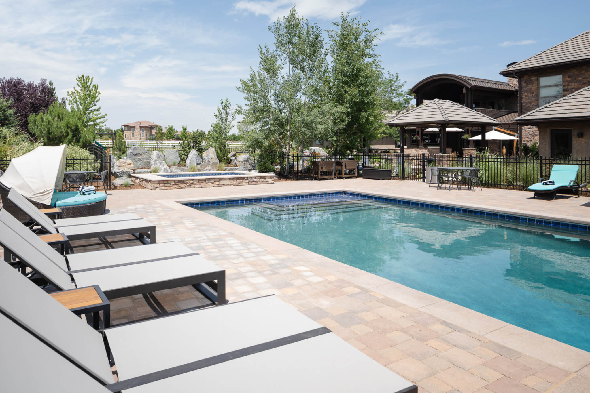 Swimming pool area with chairs and table