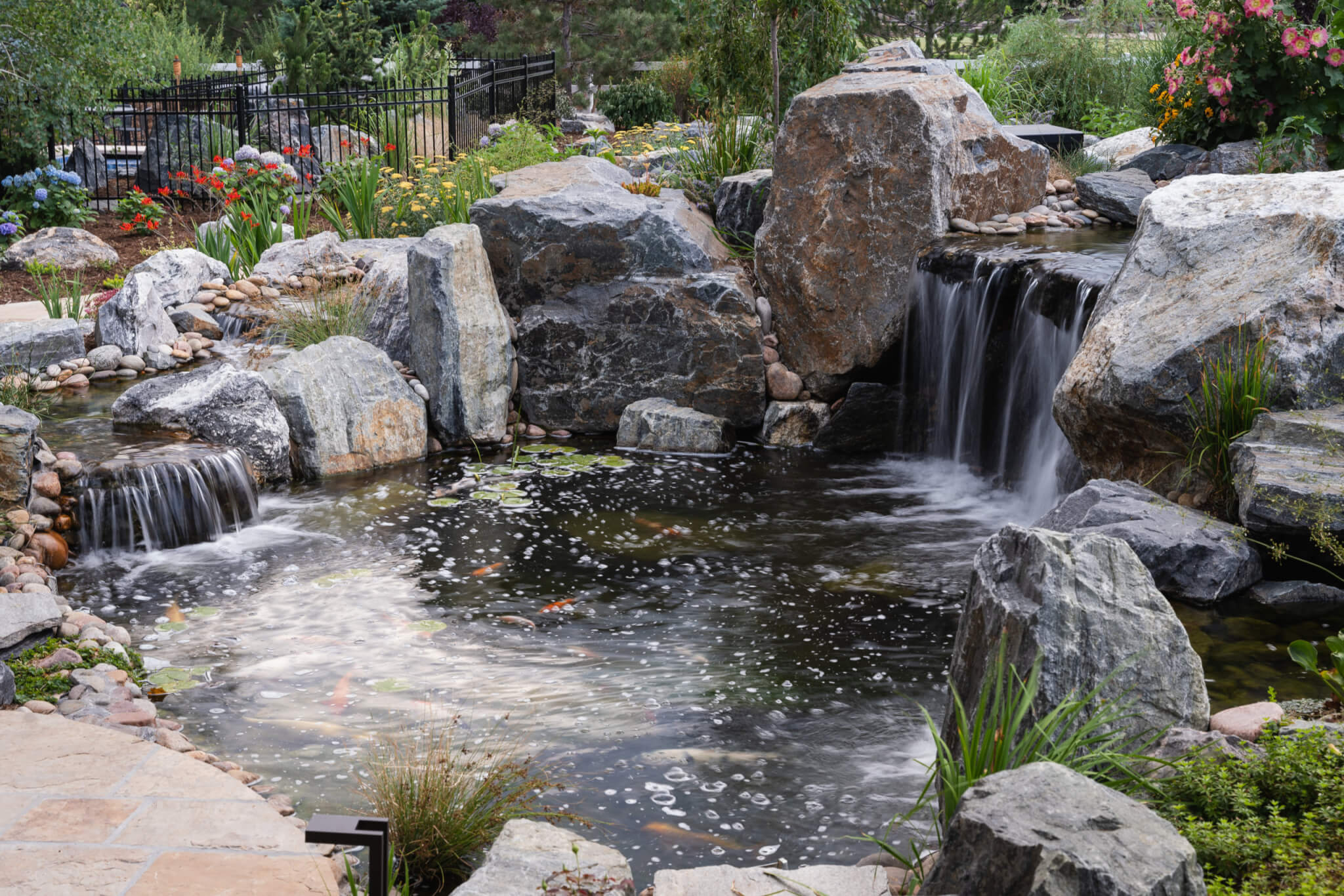 Koi fish pond with a man-made constructed mini waterfall