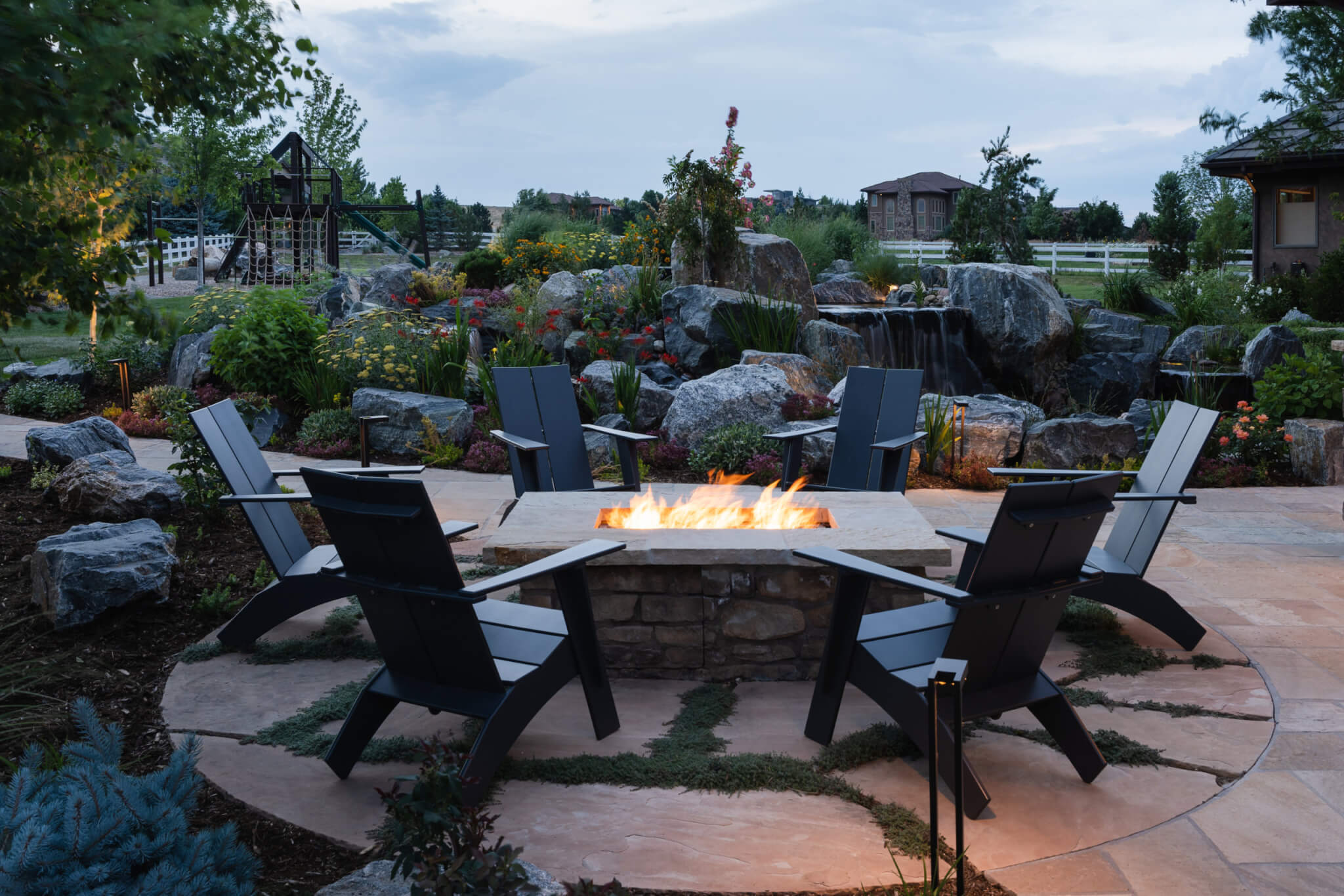 Sitting area with fire pit chairs, tables, sofas and with beautiful lightings