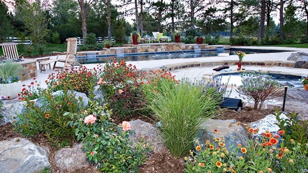 Pool Landscape Design Surrounded with Colorful Plants & Flowers