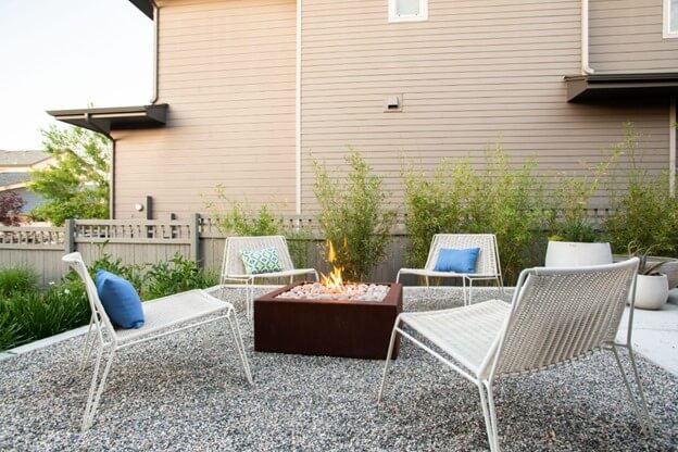 Four White Chairs Surrounding a Fire Pit