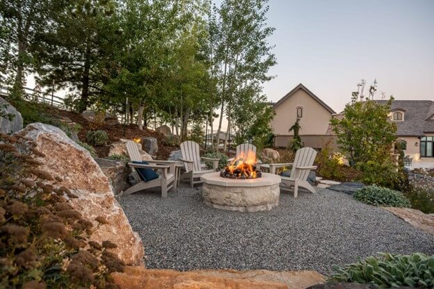 Permanent Outdoor Fire Pit Surrounded by Chairs