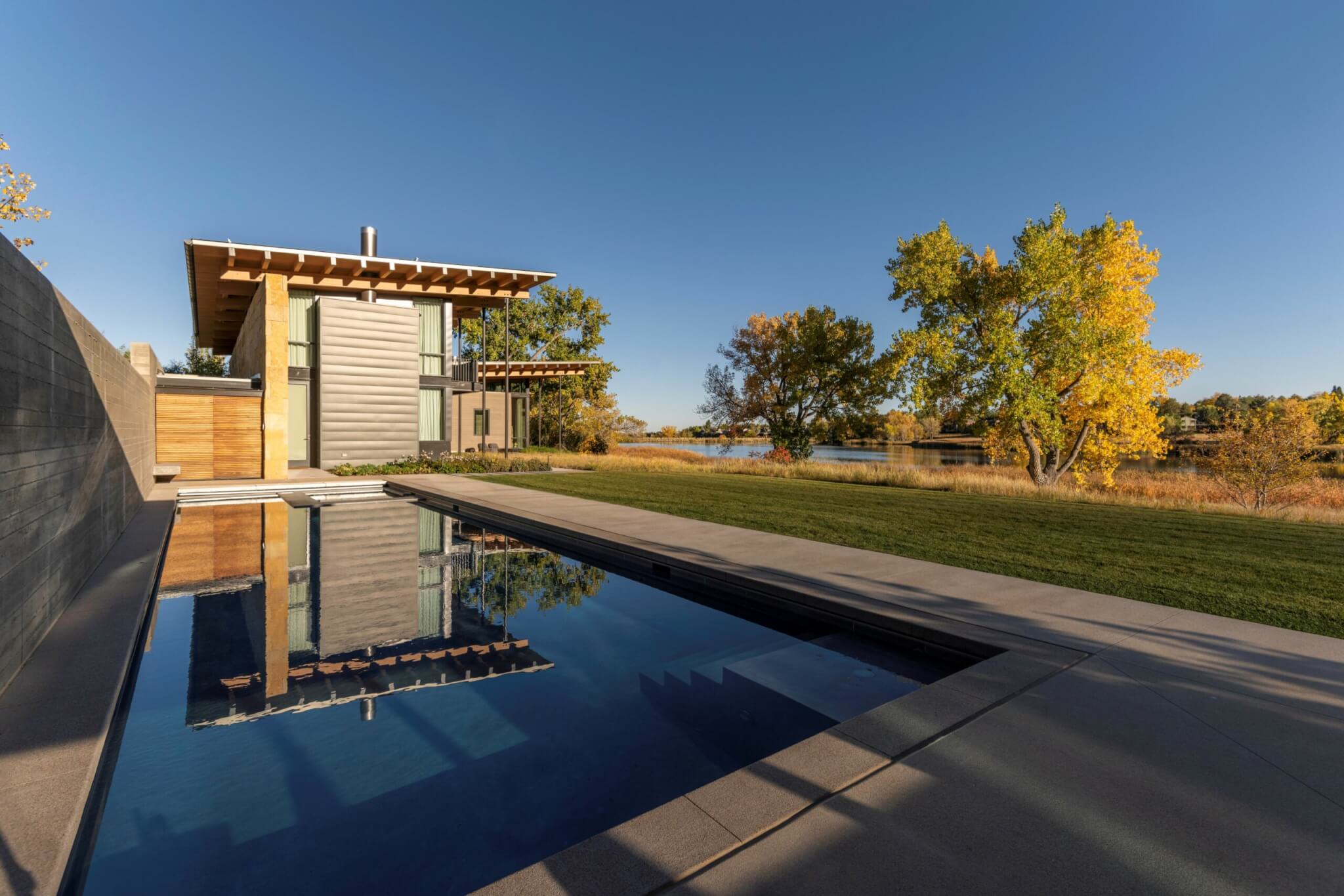 Front view of the house with swimming pool and side view with a beautiful lake